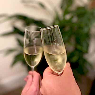 champagne glasses against a cardamom plant